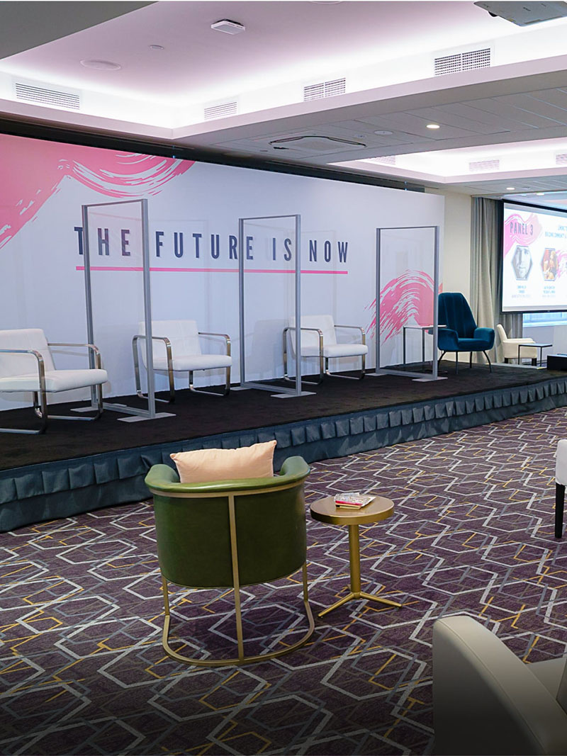 clear dividers with white chairs on stage
