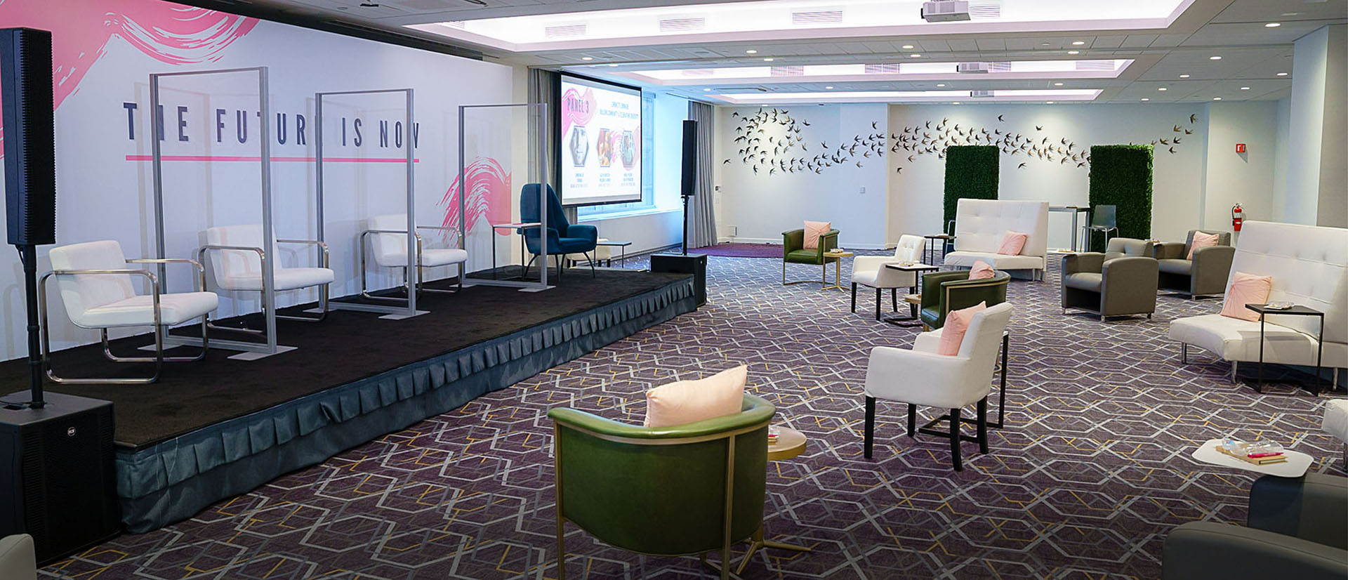 clear dividers with white chairs on stage